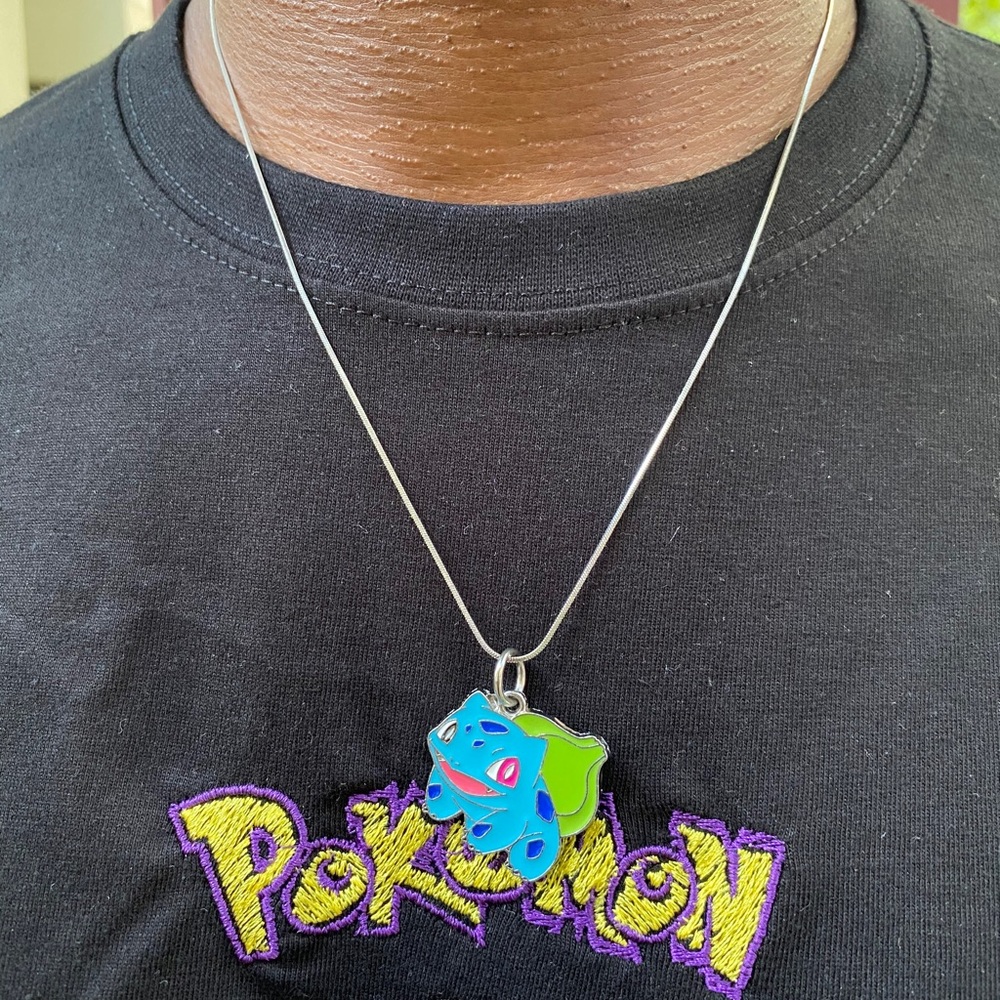 A Pokémon embroidery T shirt any size, comes with 4 Pokémon pendants.